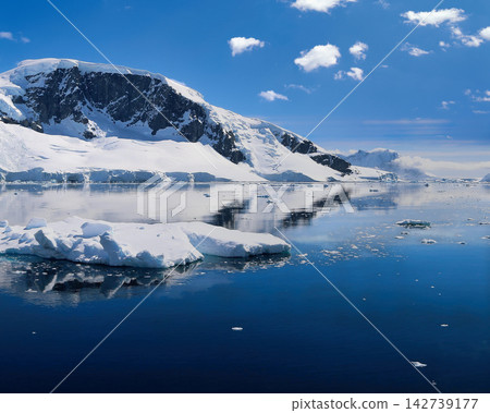 Antarctic Landscape with Icebergs and Glaciers Reflected in Calm Blue Water Antarctic Landscape with Icebergs and Glaciers Reflected in Calm Blue Water 142739177
