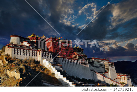 Potala Palace in Lhasa, Tibet, China, under a dramatic cloudy sky at sunset Potala Palace in Lhasa, Tibet, China, under a dramatic cloudy sky at sunset 142739213