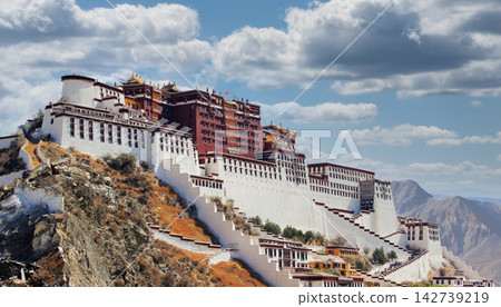 The Potala Palace in Lhasa, Tibet, China, under a blue sky with clouds The Potala Palace in Lhasa, Tibet, China, under a blue sky with clouds 142739219