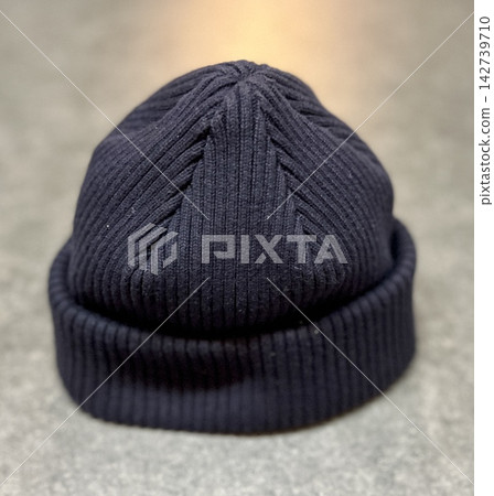 A close-up of a simple black knit hat - a winter fashion item. 142739710