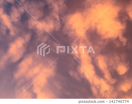Clouds floating in the sunset sky Clouds floating in the sunset sky 142740774