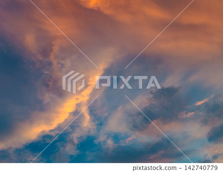 Clouds floating in the sunset sky Clouds floating in the sunset sky 142740779