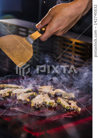 Grilling fresh vegetables at a food market in the evening Grilling fresh vegetables at a food market in the evening 142740832