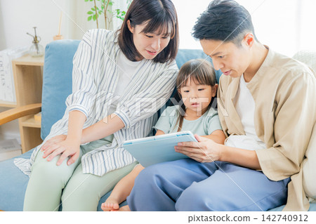 Family watching videos on a tablet Family watching videos on a tablet 142740912