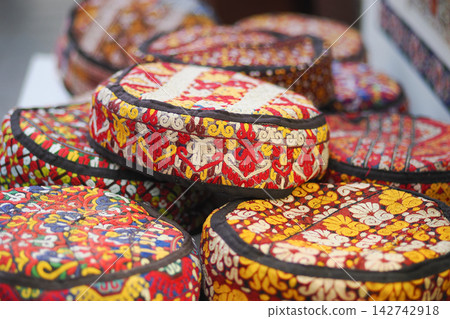 Colorful handmade hats displayed on a market stall in a local craft fair Colorful handmade hats displayed on a market stall in a local craft fair 142742918