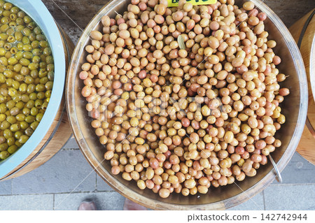 Gathering of olives at a local market in a sunny afternoon Gathering of olives at a local market in a sunny afternoon 142742944
