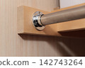 Clothes rail inside the closet 142743264