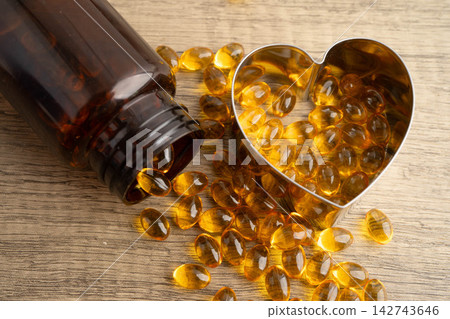 Fish oil or Cod liver oil gel in capsules with omega 3 vitamins, supplementary healthy food. Fish oil or Cod liver oil gel in capsules with omega 3 vitamins, supplementary healthy food. 142743646
