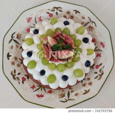 A delicate fruit tart with a golden buttery crust, creamy custard filling, and an array of colorful fresh fruits. A perfect dessert for a refreshing and elegant treat. A delicate fruit tart with a golden buttery crust, creamy custard filling, and an array of colorful fresh fruits. A perfect dessert for a refreshing and elegant treat. 142743798