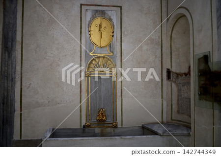 A golden antique wall clock in a historical building in Istanbul A golden antique wall clock in a historical building in Istanbul 142744349