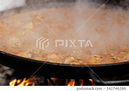 Cooking Paella Rice Over Open Fire 142746266