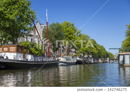 Amsterdam, Netherlands - July 02, 2018: Floating houses on the water in the center of Amsterdam 142746275