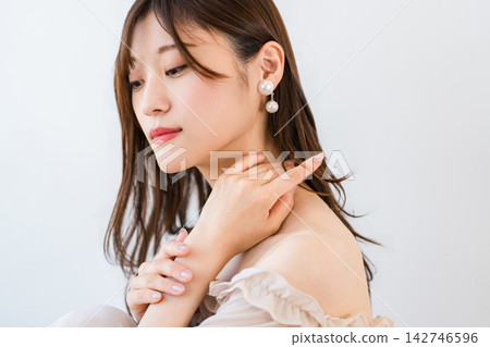 A young woman showcasing her beautiful hands and skin. Beauty products inspired by hand care and nail care. A young woman showcasing her beautiful hands and skin. Beauty products inspired by hand care and nail care. 142746596