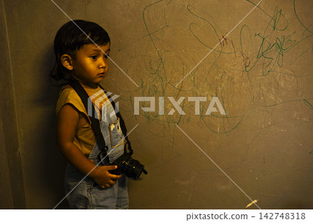 Toddler Holding Camera 142748318