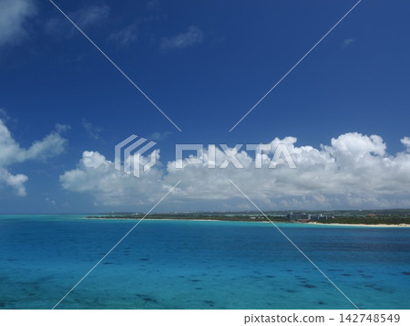 A vibrant gradient of blue stretches as far as the eye can see. A magnificent panoramic view from Kurima Island in Okinawa. 142748549