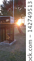 Sunset and a public telephone 142749513