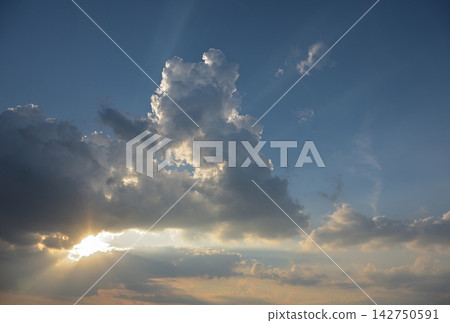 Sunlight shining through the gaps in the clouds Sunlight shining through the gaps in the clouds 142750591