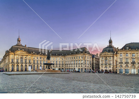 Asymmetric view of Place de la Bourse palace facade under a colorful sunset sky in Bordeaux, France. Elegant classical style Asymmetric view of Place de la Bourse palace facade under a colorful sunset sky in Bordeaux, France. Elegant classical style 142750739