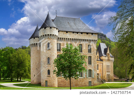 Chateau de Campagne in France. Historical medieval stone castle under partly cloudy sky 142750754