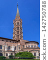 Low angle view of Basilica of Saint-Sernin in Toulouse, France. Romanesque apse and tall bell tower in vertical framing 142750788