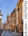 Street view of the old town in Toulouse, France. Perspective on the octagonal bell tower of Saint-Sernin under blue sky 142750792