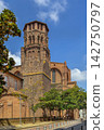 Low angle view of Augustinian Convent bell tower in Toulouse, France. Southern Gothic brick tower under blue sky 142750797