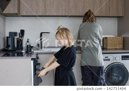Children in kitchen. Blonde girl and boy portrait Children in kitchen. Blonde girl and boy portrait 142751404