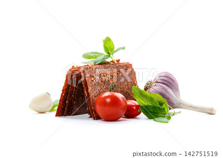 Homemade dried tomato sheets with vegetables on white background Homemade dried tomato sheets with vegetables on white background 142751519
