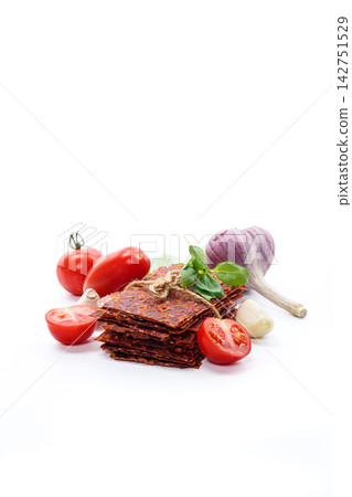 Savory tomato pastila with fresh basil on white background Savory tomato pastila with fresh basil on white background 142751529
