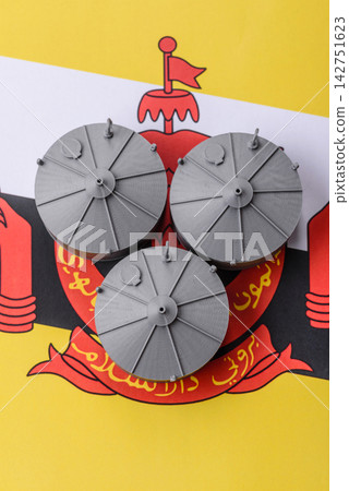 Liquefied gas storage tanks set against the Brunei flag, representing the concept of supply Liquefied gas storage tanks set against the Brunei flag, representing the concept of supply 142751623