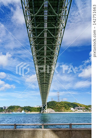 The magnificent Kanmon Bridge stretches across the Kanmon Strait under a clear blue sky. The magnificent Kanmon Bridge stretches across the Kanmon Strait under a clear blue sky. 142751663