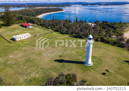 Description: Aerial view of Yamba Lighthouse on Pilot Hill, with the Clarence River, estuary and surrounding coastal landscape visible in the background in New South Wales, Australia. Description: Aerial view of Yamba Lighthouse on Pilot Hill, with the Clarence River, estuary and surrounding coastal landscape visible in the background in New South Wales, Australia. 142752213