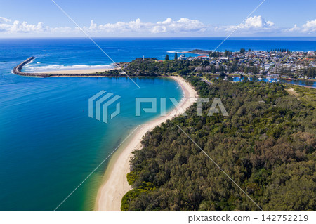Description: Aerial view of Whiting Beach extending toward Pilot Hill and the Clarence River entrance breakwall at Yamba, New South Wales, Australia. Description: Aerial view of Whiting Beach extending toward Pilot Hill and the Clarence River entrance breakwall at Yamba, New South Wales, Australia. 142752219