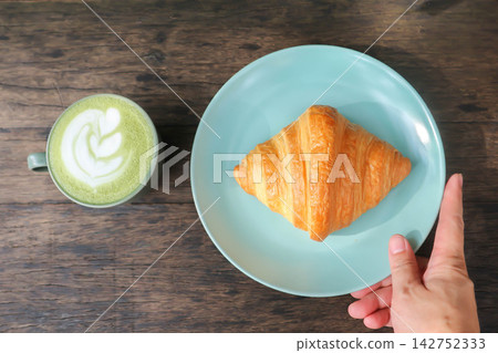 croissant , French croissant or French bread and green tea or matcha green tea, milk green tea or matcha latte or matcha green tea latte croissant , French croissant or French bread and green tea or matcha green tea, milk green tea or matcha latte or matcha green tea latte 142752333