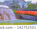The splashes of water from the pond and the vibrant autumn leaves of the kochia plants. 142752501