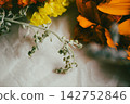 Macro shot of fresh marigold and statice flowers with wormwood sprig 142752846