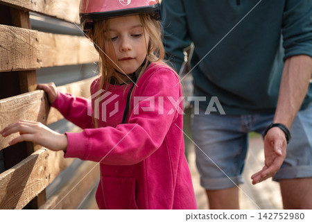 Young Girl Learning New Skill, Roller Skating Outdoors, Confidence Building, Child Development, Active Parenting And Family Support Concept Young Girl Learning New Skill, Roller Skating Outdoors, Confidence Building, Child Development, Active Parenting And Family Support Concept 142752980