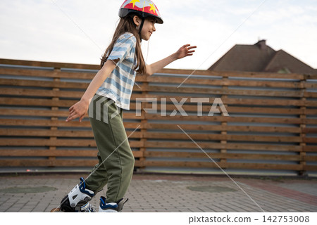 Girl Wearing Safety Helmet While Roller Skating Outdoors, Active Childhood, Child Safety And Screen Free Active lifestyle Girl Wearing Safety Helmet While Roller Skating Outdoors, Active Childhood, Child Safety And Screen Free Active lifestyle 142753008