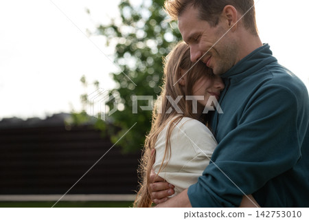 Father Hugging Teenage Daughter Outdoors, Family Bonding, Parent Teen Relationship Concept Father Hugging Teenage Daughter Outdoors, Family Bonding, Parent Teen Relationship Concept 142753010