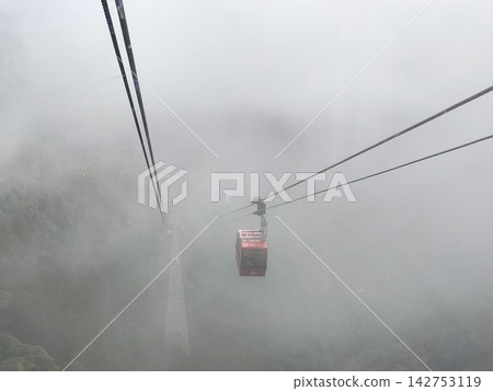 The scenery of a cable car moving through the fog The scenery of a cable car moving through the fog 142753119