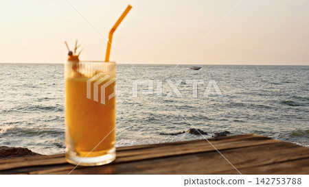 Tropical Drink On Wooden Table By Sea In Warm Sunlight With Copy Space For Advertising. Summer Refreshment And Seaside Vacation Concept. 142753788