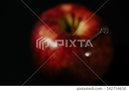 a red apple and nails on it a red apple and nails on it 142754638
