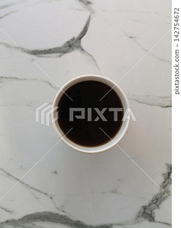 a cup of coffee on the table a cup of coffee on the table 142754672