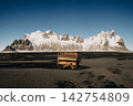 Weathered piano on the black sand of Stokksnes beach with Vestrahorn mountains in the background, South East Iceland 142754809
