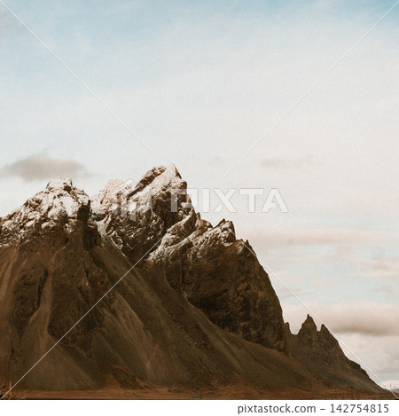 Dramatic peaks of Vestrahorn mountains dusted with snow in Stokksnes, South East Iceland Dramatic peaks of Vestrahorn mountains dusted with snow in Stokksnes, South East Iceland 142754815