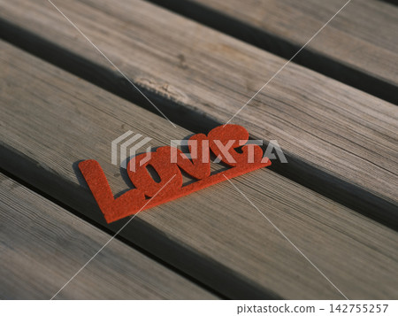 red decorative love lettering on wooden board 142755257