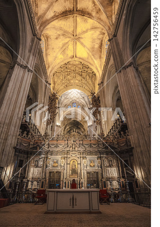 Gothic vaulted nave ceiling and gilded altarpiece inside Seville Cathedral, Spain Gothic vaulted nave ceiling and gilded altarpiece inside Seville Cathedral, Spain 142756459
