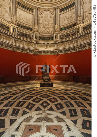 Elliptical domed chapter house of Seville Cathedral with red damask walls and archbishop's throne Elliptical domed chapter house of Seville Cathedral with red damask walls and archbishop's throne 142756492
