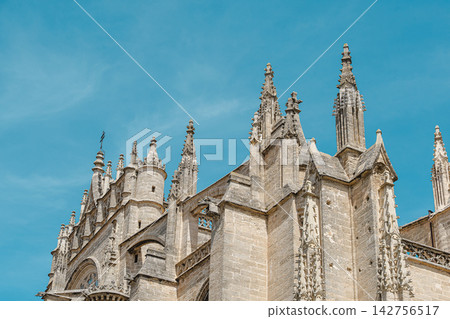 Weathered gothic spires and pinnacles atop Seville Cathedral Weathered gothic spires and pinnacles atop Seville Cathedral 142756517