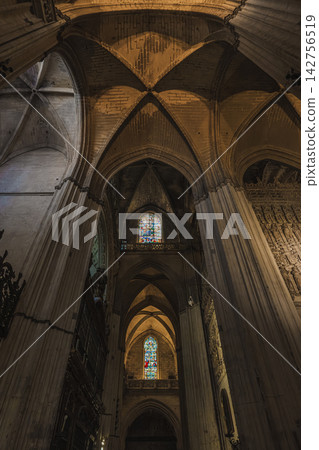 Gothic ribbed vaults and stained glass window inside Seville Cathedral, Spain Gothic ribbed vaults and stained glass window inside Seville Cathedral, Spain 142756519